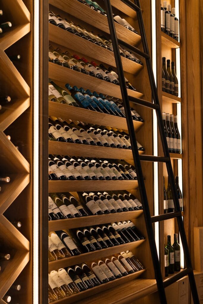 Elegant wine cellar with diverse bottles on wooden shelves in Baku.